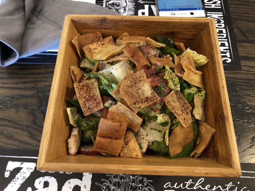 Fattoush · Delicious mix of lettuce, green peppers, chopped Italian parsley, cucumbers, and tomatoes. Lemon juice and olive oil dressing. Topped with sumac. Served with toasted pita bread.