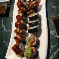 Underground Dragon Roll · Eel and avocado wrapped roll with seaweed salad in the bottom.