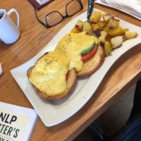 Harbor Benedict · Toasted Croissant, fresh avacado, tomatoes, 2 poached eggs, hollandaise sauce on top served ...
