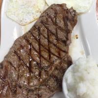Steak and Eggs · 10 oz. ribeye served with two eggs any style, home fries or grits, and toast.