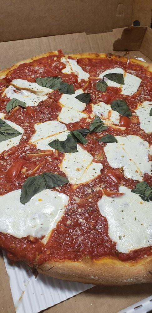 Margherita Pizza · Chunky tomato, fresh mozzarella, basil and extra virgin olive oil.