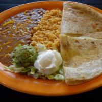Quesadilla · Soft flour tortillas stuffed with melted cheese, onions and tomatoes. Served with sour cream...