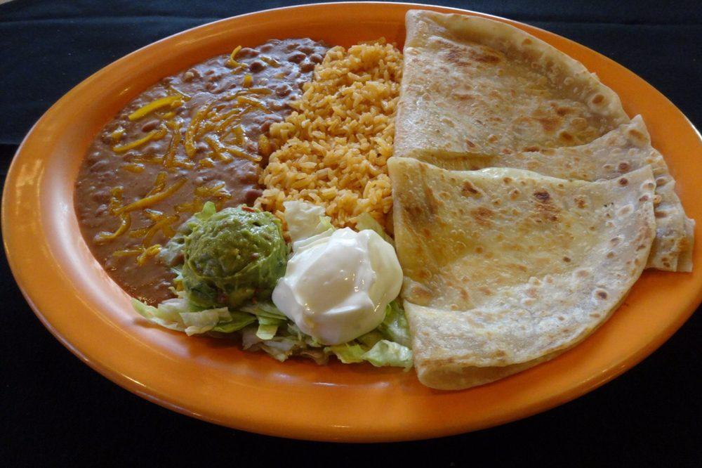 Quesadilla · Soft flour tortillas stuffed with melted cheese, onions and tomatoes. Served with sour cream and guacamole. Add chicken, ground beef or shredded beef  or carne asada for  an additional charge.