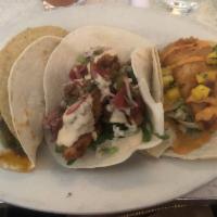 Baja Fish Taco · Beer-battered fish with spicy slaw, mango salsa, and special sauce. Served on soft corn tort...