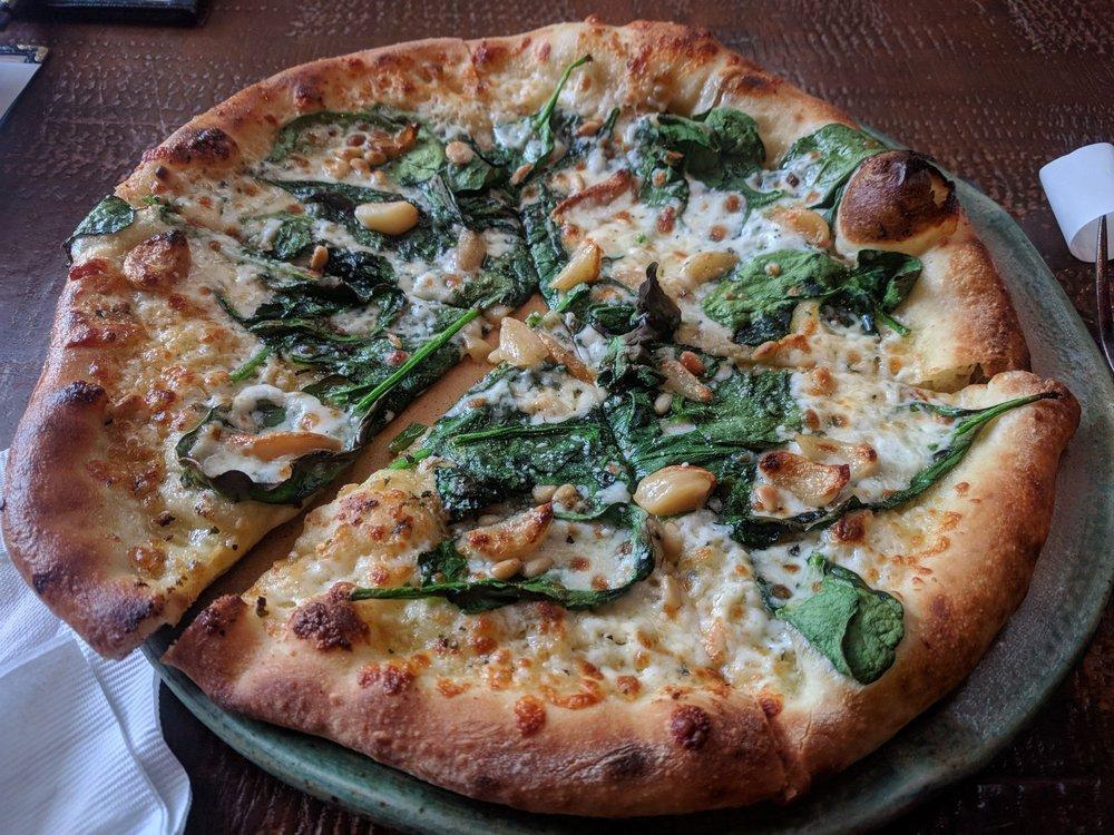 Spinach and Garlic Pizza · Herbed olive oil, spinach, roasted garlic cloves, pine nuts, and spin blend cheese.