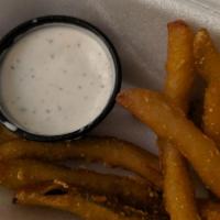 Leprechaun Strings · Fresh pickle chips lightly breaded and served with a side of our homemade ranch dipping sauce.