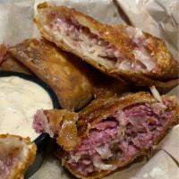 Reuben Egg Rolls · Slow cooked corned beef, sauerkraut and Swiss, rolled by hand and deep-fried. Served with ho...