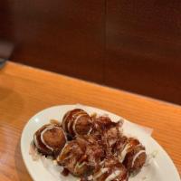 Takoyaki · Plump fried dough balls with octopus inside. Covered in sauce and mayo, topped with bonito f...