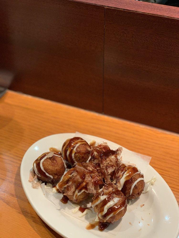 Takoyaki · Plump fried dough balls with octopus inside. Covered in sauce and mayo, topped with bonito flakes.