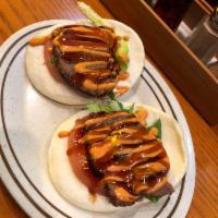 Pork Buns · A pair of steamed buns. Served with tomato and lettuce.