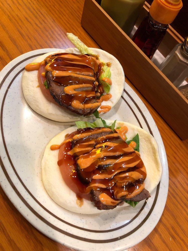 Pork Buns · A pair of steamed buns. Served with tomato and lettuce.