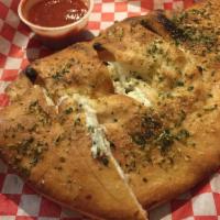 Meat Calzone · Mozzarella cheese, ricotta cheese, pepperoni and Italian sausage. Served with marinara sauce...