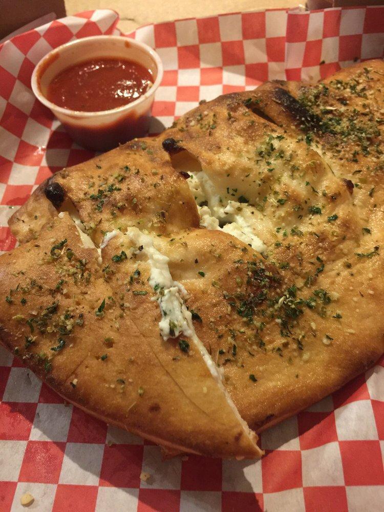 Meat Calzone · Mozzarella cheese, ricotta cheese, pepperoni and Italian sausage. Served with marinara sauce on the side.