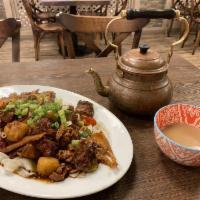 Big Plate Chicken Stew · spicy chicken, potatoes, garlic and ginger braised in traditional Uyghur spices served with ...