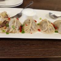 Dumplings · 10 hand-made dumplings filled with minced beef, cabbage, onions.