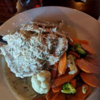 Dublin Rosemary Chicken · Grilled breast of chicken served with garlic mashed potatoes and fresh veggies. Finished wit...