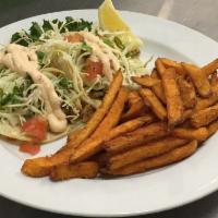 Fish Tacos · Charbroiled cod on corn tortillas topped with chipotle aioli, shredded cabbage and served wi...