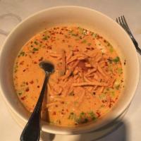 Kao Soi · Egg noodles in a bowl of northern Thai curry sauce with chicken, cilantro, and scallions. Ad...