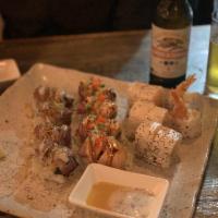 Taurus Roll · Tuna paired with fried onions, maitake mushrooms inside, topped with Kobe beef, drizzled in ...