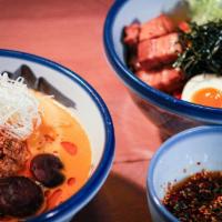 Tonkotsu Tantanmen ·  Thick noodles, sesame tare, tonkotsu broth, topped with shiitake mushrooms simmered in whit...