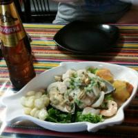 Ceviche Mixto · It's made with fish strips, shrimp, calamari and mussels marinated in lemon juice and Peruvi...