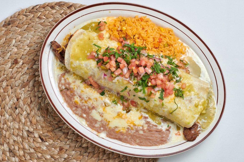 Burrito Verde · Flour tortilla stuffed with steak or grilled chicken, beans, rice, and cheese, topped with cheese dip and tomatillo sauce, and pico de gallo. Served with rice and beans