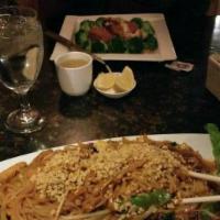 Pad Thai · Thin flat rice noodles with bean sprouts, red and green onions and eggs. Served with lime. M...
