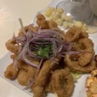 Jalea Mixta · Deep-fried seafood, calamari, fish and shrimp topped with onion salad, tomatoes, cilantro, c...
