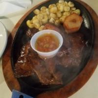 Anticuchos · Two grilled skewers of cow heart with Peruvian seasoning.