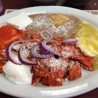 Huevos Divorciados · 2 eggs with chilaquiles, cheese, and beans.