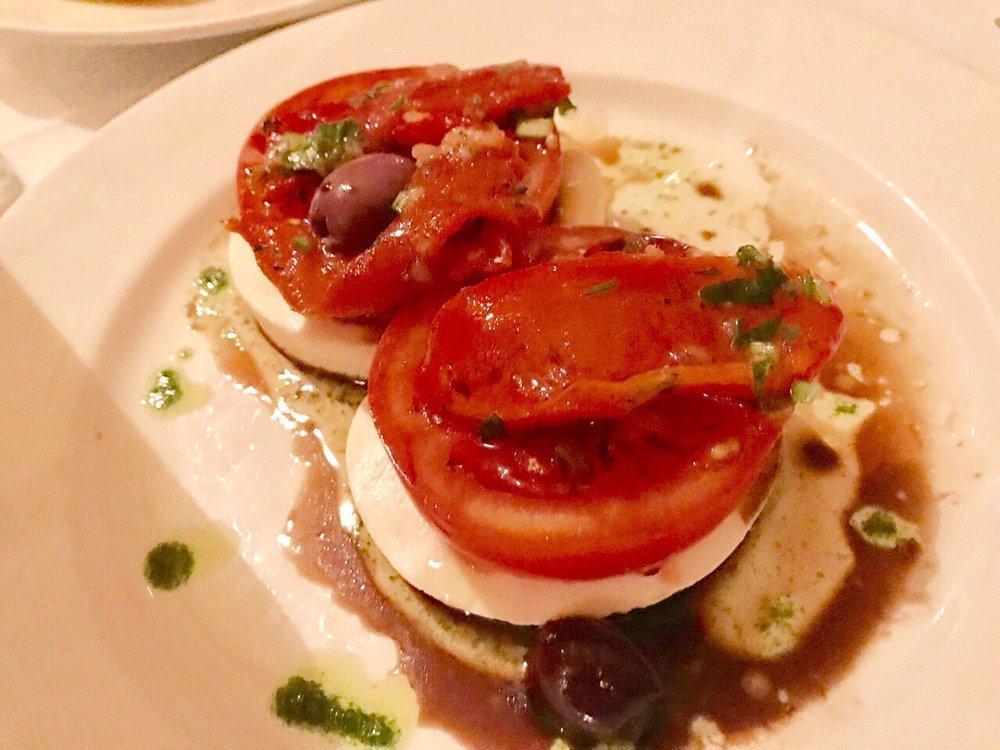 Mozzarella Caprese · Fresh mozzarella with sliced tomatoes, roasted red peppers and fresh basil.