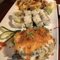 Volcano Roll · Salmon, tuna, and cucumber inside with baked crab and special sauce on top.