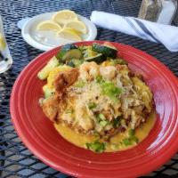 Chicken Bon Ton · Southern fried chicken breast smothered with shrimp and crab in a creamy alfredo sauce serve...
