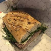 Roast Beef Panini · Roast beef, Brie cheese, caramelized onions, arugula and horseradish.