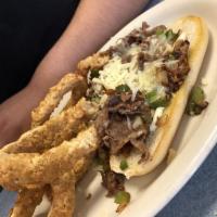 Beef and Chicken Philly Sandwich · Beef and chicken philly, topped with bell peppers and onions, melted mozzarella cheese and m...