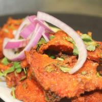 Crispy Andhra Masala Fried Fish · Chef's special spiced fish cubes deep fried and served with salted green chilies.