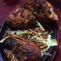 Tandoori Chicken · Tender bone - in chicken, marinated with exotic tandoori spices, roasted in clay oven, serve...