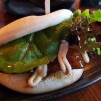 Jinya Bun · Steamed bun stuffed with slow braised pork chashu, cucumber and baby mixed greens served wit...