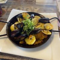 Paella · Traditional Spanish saffron rice dish made with shrimp, clams, mussels & scallop. Spicy.