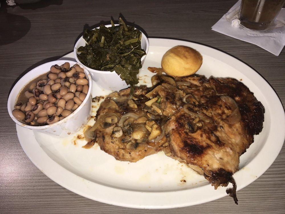 Smothered Pork Chops · 2 pork chops smothered with our house made brown gravy, caramelized onions and white button mushrooms. Served with red beans and rice, green beans and our traditional cornbread.