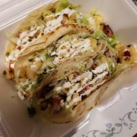 Jerk Chicken Taco · 3 House smoked jerk chicken tacos, shredded lettuce, pineapple salsa, crema and Cotĳa cheese.