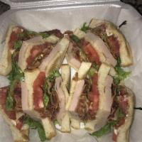 Turkey Club · Roasted turkey breast, lettuce, tomato, bacon and mayonnaise. Served on toasted bread.