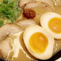 Classic Ramen · Our signature tonkotsu pork broth topped with 2 slices of Chashu pork and Green Onions.