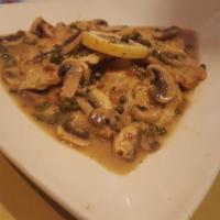 Veal Piccata · Veal sauteed in an egg batter in a lemon and white wine sauce topped with mushrooms and cape...