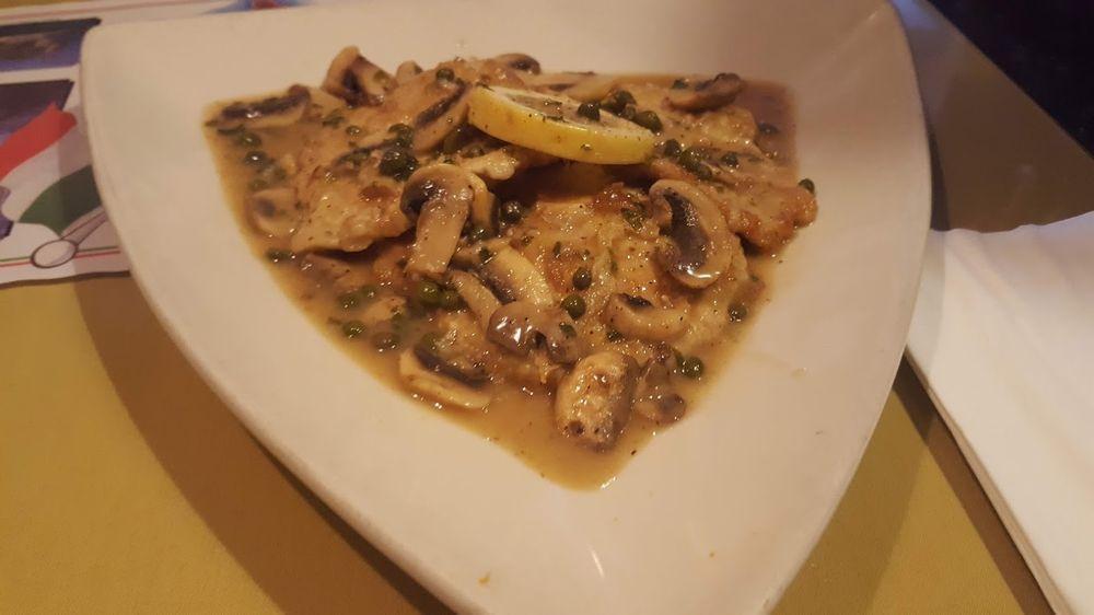 Veal Piccata · Veal sauteed in an egg batter in a lemon and white wine sauce topped with mushrooms and capers. Served with soup or salad and garlic bread.