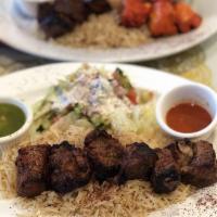 Lamb Kebab · 6 tender pieces of lamb charbroiled to perfection. All kabobs served with rice, salad and sh...