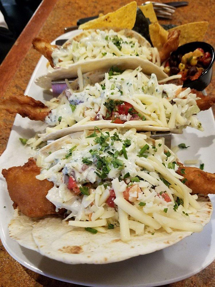 Fish Tacos · flour tortillas stuffed with beer battered atlantic cod, topped with fresh pico, jack cheese, coleslaw, and cilantro sour cream, with tortilla chips 