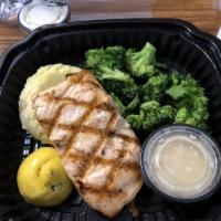 Grilled Salmon · grilled atlantic salmon served with lemon butter sauce, garlic mashed potatoes and chef’s se...