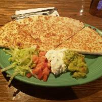 Quesadillas · Large flour tortilla filled with a blend of melted cheeses. Served with lettuce, tomato, sou...