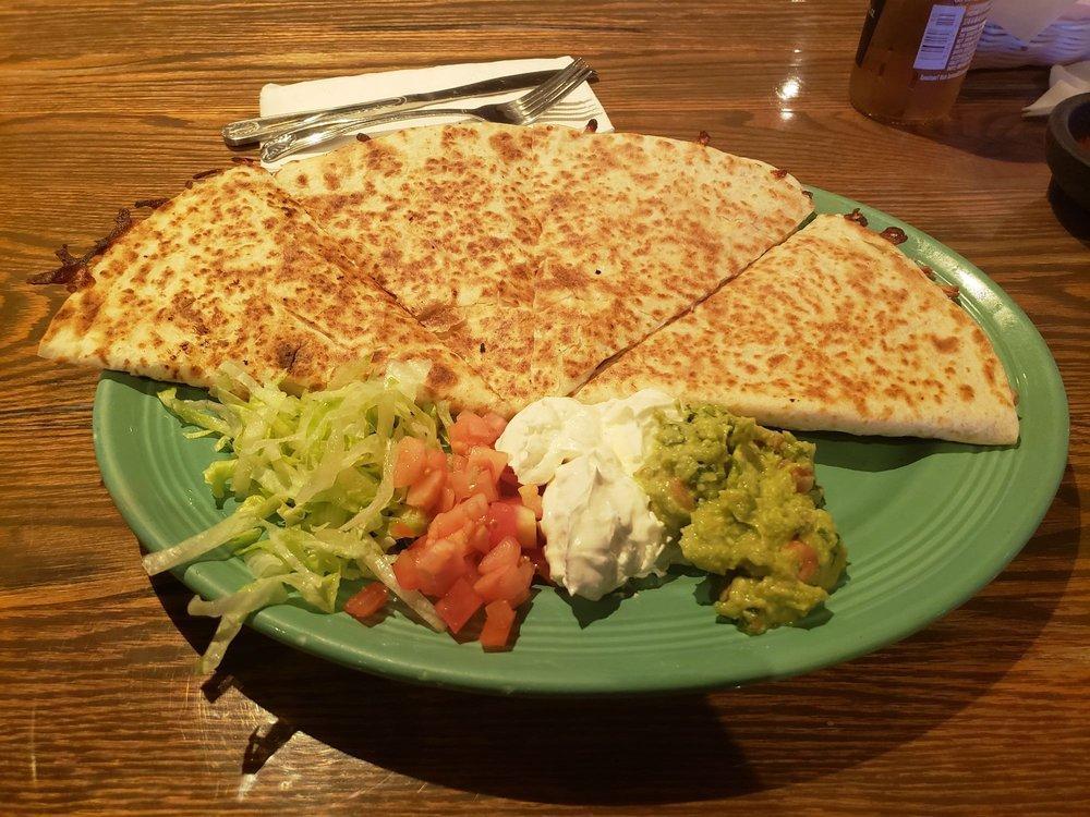 Quesadillas · Large flour tortilla filled with a blend of melted cheeses. Served with lettuce, tomato, sour cream and guacamole.